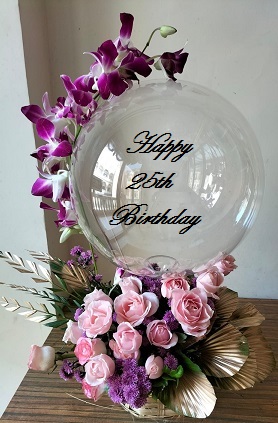 Transparent Balloon with 1 Purple Orchid trailing on the balloon tied to 12 pink and white roses basket
