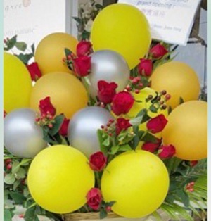 15 yellow silver balloons arranged in basket with 15 red roses