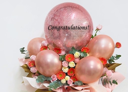 20 pink white flowers 4 small pink balloons and one large bobo balloons with confetti and Congratulations on balloon