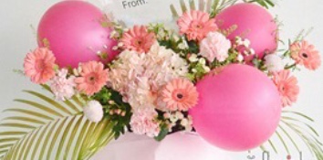 3 pink balloons with gerberas and carnations with palm leaves